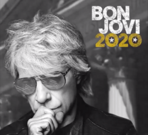 Reprodução da capa do álbum '2020', de Bon Jovi. Trata-se de uma foto em preto e branco do busto de Jon Bon Jovi visto de frente, com a mão direita na boca e óculos escuros nos quais cada lente reflete uma imagem da bandeira dos Estados Unidos. O nome da banda (em branco) e o do disco (dourado, com uma estrela dentro de cada zero) aparecem no topo, à direita